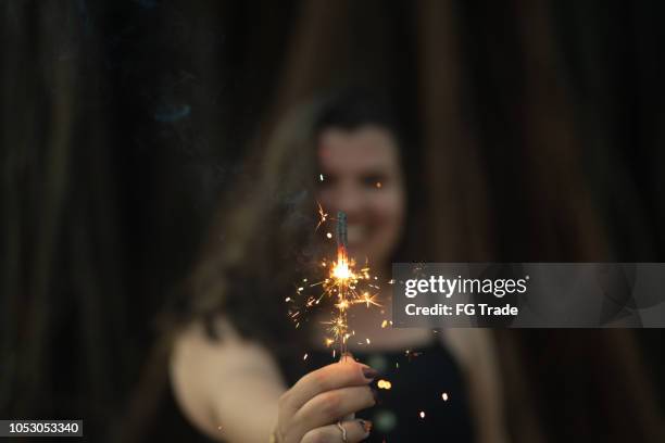 happy woman burning sparklers - spark imagination stock pictures, royalty-free photos & images