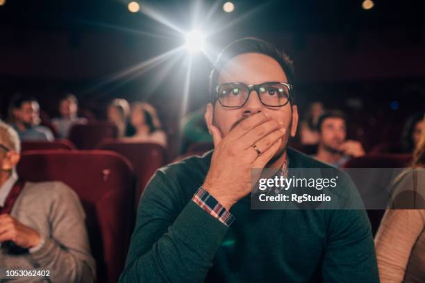 scared man at cinema - horror movie stock pictures, royalty-free photos & images