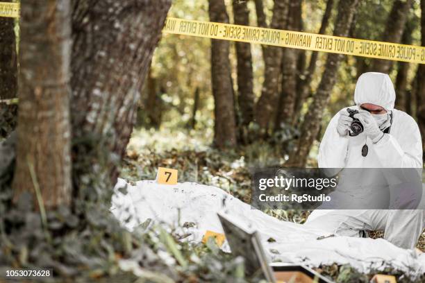 man taking photos of an open crime scene - barricade stock pictures, royalty-free photos & images