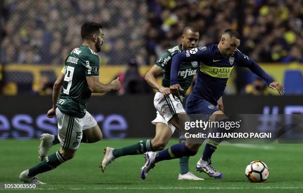 Argentina's Boca Juniors forward Mauro Zarate controls the ball past Brazil's Palmeiras midfielder Bruno Henrique and defender Mayke during a Copa...