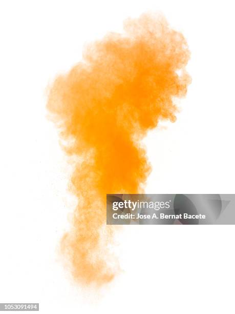 full frame of forms and textures of an explosion of powder and smoke of color orange on a white background. - colored smoke stock-fotos und bilder