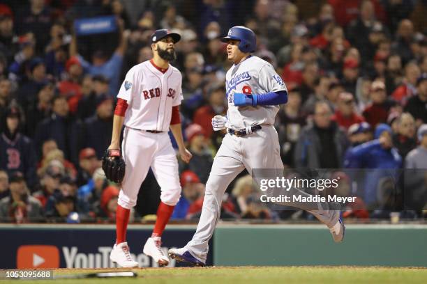 David Price of the Boston Red Sox looks on as Manny Machado of the Los Angeles Dodgers scores a fourth inning run in Game Two of the 2018 World...