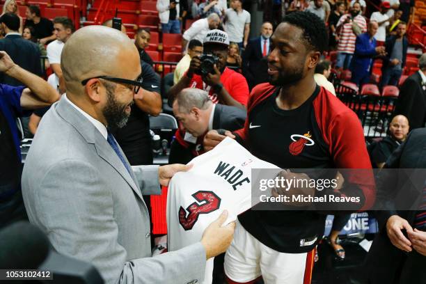 Dwyane Wade of the Miami Heat presents head coach David Fizdale of the New York Knicks with a jersey after the game at American Airlines Arena on...