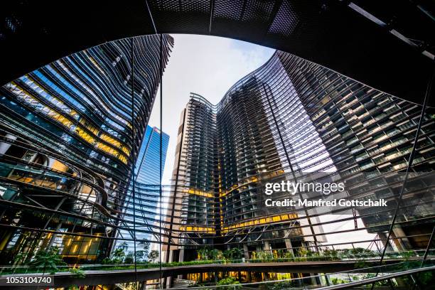 marina one, mixed-use highrise development, consisting of two residential and one commercial tower, mole's eye view of 'the heart', a civic space between the towers with lush greenery, sindapore, marina south - civic buildings stock pictures, royalty-free photos & images