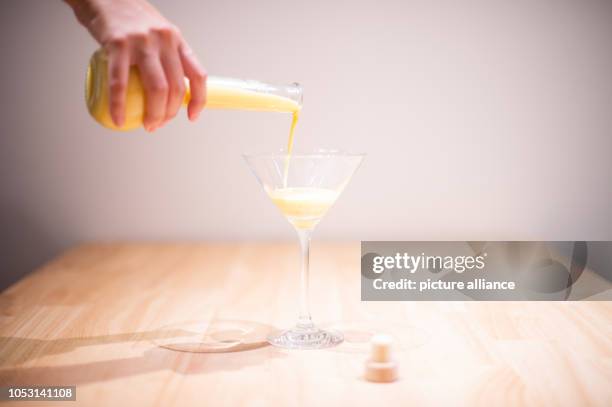 October 2018, Berlin: 24 October 2018, Germany, Berlin: ILLUSTRATION - A woman pours egg liqueur. On 25 October 2018, the European Court of Justice...