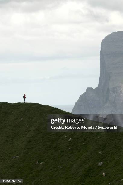 hiker on mountain ridge, faroe islands - be boundless summit stock pictures, royalty-free photos & images