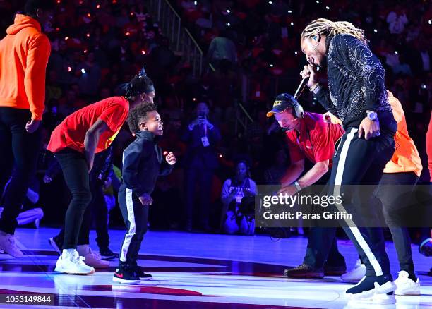 Rapper Future performs in concert with his son Future Zahir Wilburn during halftime of the game between the Dallas Mavericks and the Atlanta Hawks on...
