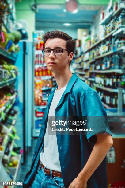 jonge man in een supermarkt - hip stockfoto's en -beelden