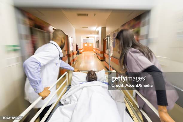 rushing a patient to the emergency room - hospital gurney stock pictures, royalty-free photos & images