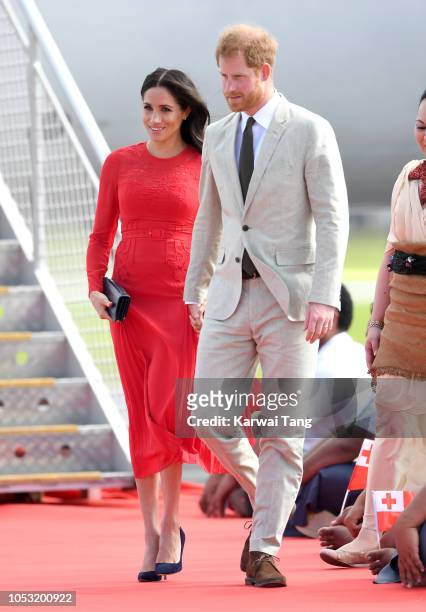 Meghan, Duchess of Sussex and Prince Harry, Duke of Sussex arrive at Fua'amotu Airport on October 25, 2018 in Nuku'alofa, Tonga. The Duke and Duchess...