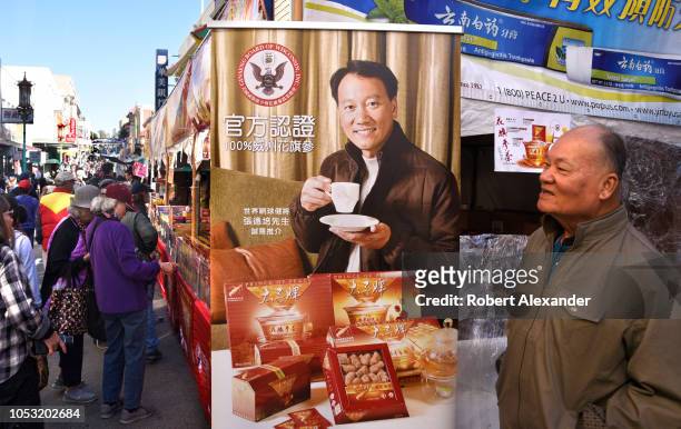 Booth at a street festival in Chinatown, San Francisco, California, promotes and sells herbal tea made from ginseng grown in Wisconsin, USA. The...
