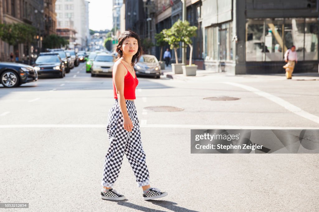Young woman crossing a city street