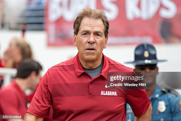 Head Coach Nick Saban of the Alabama Crimson Tide jogs onto the field after halftime during a game against the Arkansas Razorbacks at Razorback...