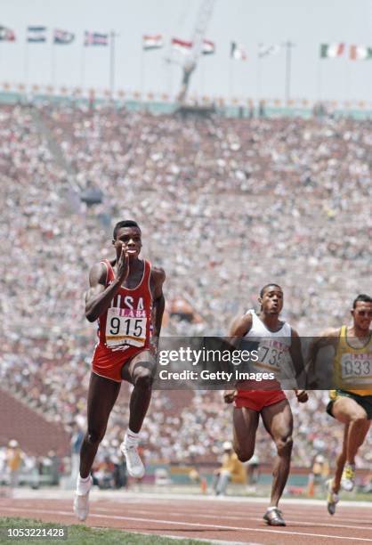 Sprinter Carl Lewis in action during the Mens 100 Metres Heats with Peter Van Miltenburg of Australia at the Los Angeles Memorial Coliseum on August...