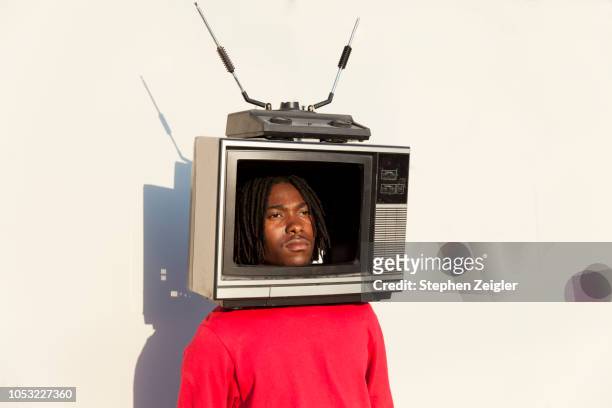 portrait of a young man with a tv set on his head - television host stock pictures, royalty-free photos & images
