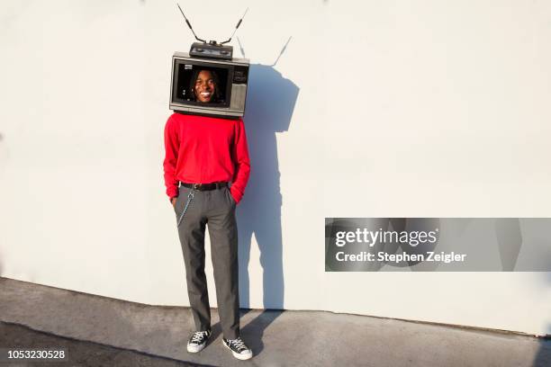 smiling man with a television set on his head - funny black people faces stock pictures, royalty-free photos & images