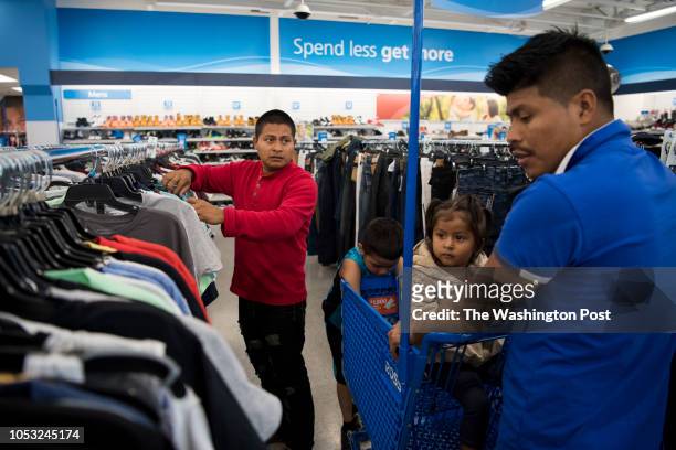 Carlos Aldana and his brother Rodolfo Aldana go shopping to buy Carlos and his daughter Alejandra clothes at Ross Dress for Less in Seattle,...
