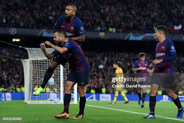 Jordi Alba of FC Barcelona celebrates with his team mate Arturo Vidal after scoring his team's second goal during the Group B match of the UEFA...