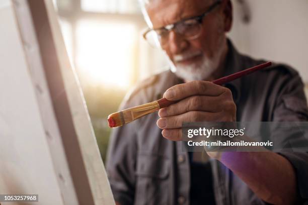 portrait of a man painting - pintar imagens e fotografias de stock