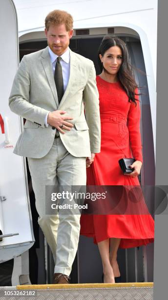 Prince Harry, Duke of Sussex and Meghan, Duchess of Sussex arrive at Nuku'alofa airport on October 25, 2018 in Nuku'alofa, Tonga. The Duke and...