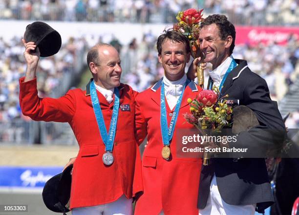 Andrew Hoy of Australia , David O''Connor of the USA and Mark Todd of New Zealand celebrate on the podium after the Individual Three Day Event Show...