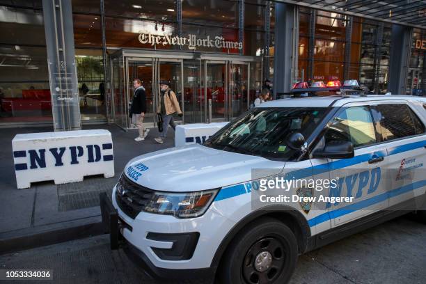 New York City Police vehicles sit parked outside the office of the The New York Times, October 25, 2018 in New York City. Security is being ramped up...
