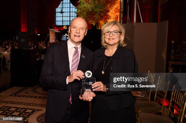 President of MSNBC, Phil Griffin poses with an award presented by Journalist Cynthia McFadden during the International Women's Media Foundation's...