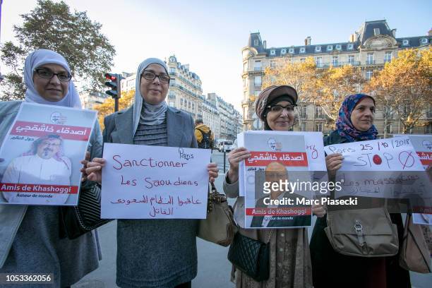 Demonstrators hold signs protesting over the killing of Jamal Khashoggi, the Saudi journalist allegedly murdered at Saudi Arabia's Istanbul consulate...