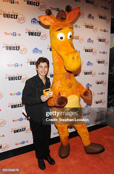 Actor Jake Austin and Toys "R" Us mascot Geoffrey the Giraffe attend Trick-or-Treat for UNICEF 60th Anniversary Celebration at The Xchange on October...