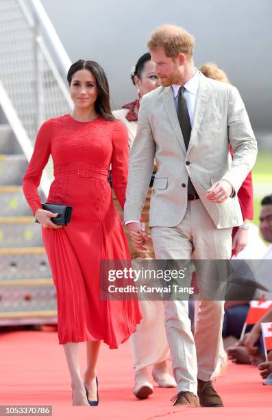 Meghan, Duchess of Sussex and Prince Harry, Duke of Sussex arrive at Fua'amotu Airport on October 25, 2018 in Nuku'alofa, Tonga. The Duke and Duchess...