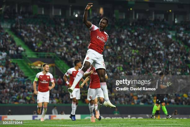 Danny Welbeck of Arsenal celebrates with team mates after scoring his sides first goal during the UEFA Europa League Group E match between Sporting...