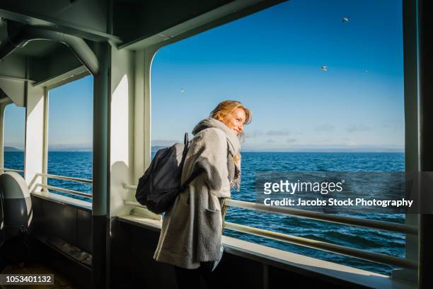 young woman on ferry boat - fähre stock-fotos und bilder