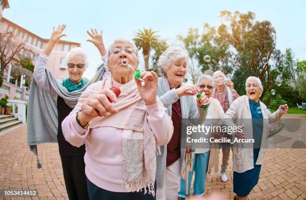 bubbles brings out your inner child! - senior women dancing stock pictures, royalty-free photos & images