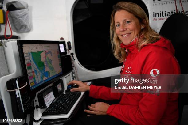 British skipper Samantha Davies poses on her Imoca monohull boat Initiatives-Coeur in Saint-Malo, western France, on October 25 few days prior to the...