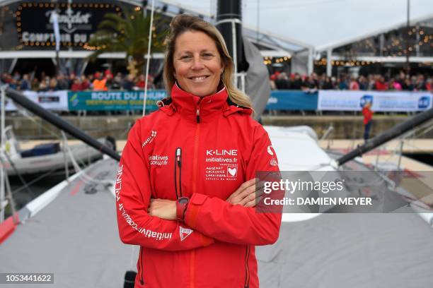 British skipper Samantha Davies poses on her Imoca monohull boat Initiatives-Coeur in Saint-Malo, western France, on October 25 few days prior to the...