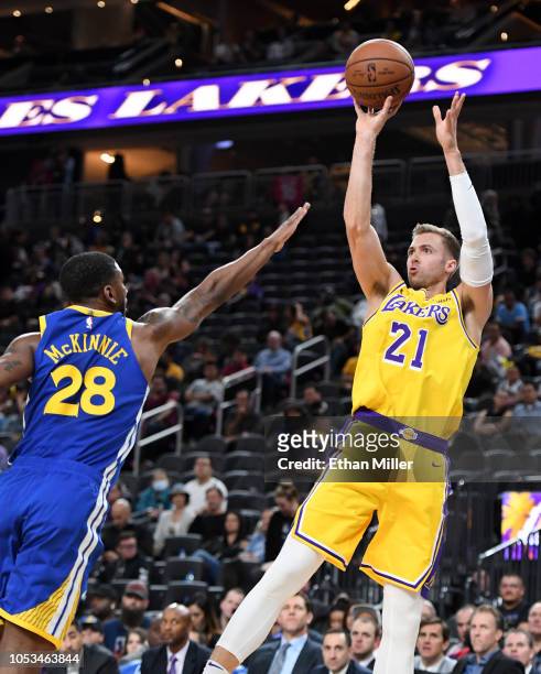 Travis Wear of the Los Angeles Lakers shoots against Alfonzo McKinnie of the Golden State Warriors during their preseason game at T-Mobile Arena on...