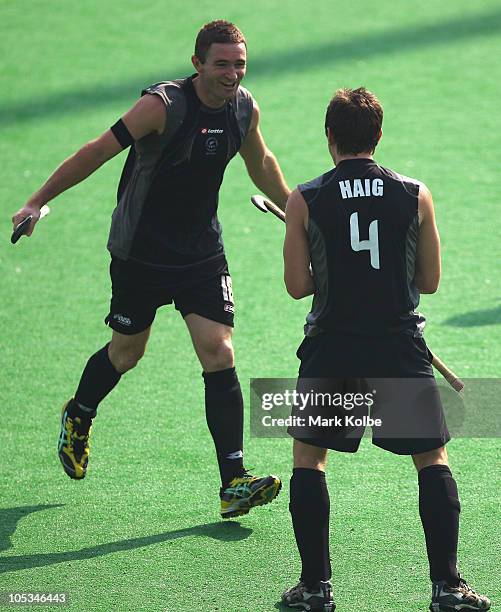 Phil Burrows and Nick Haig of New Zealand celebrate their second goal during the Men's Bronze medal match between New Zealand and England at the...