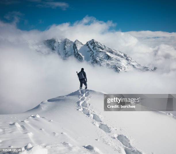 hiking in the mountains - climbing snow mountain imagens e fotografias de stock