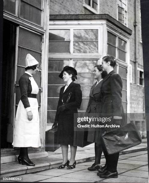 Girls arrive at the St. Charles's Training Centre in London to start their training as nurses, and are given a warm welcome by a Sister, England,...