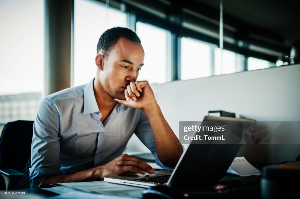 Office Worker Using Laptop At His Desk