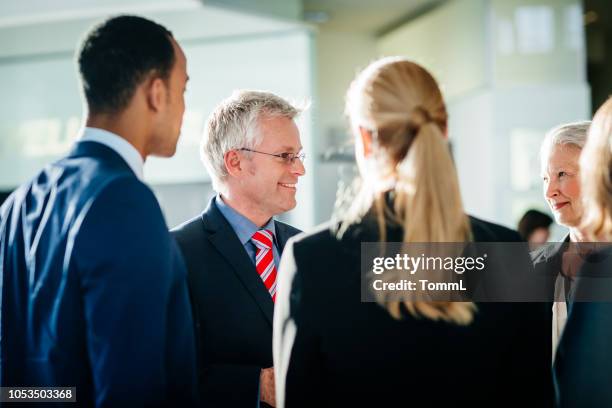 shareholders talking to business team leaders - shareholder stock pictures, royalty-free photos & images