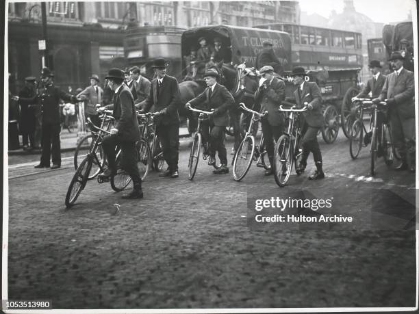 Men cycling to the City during the Great Railway Strike, London.