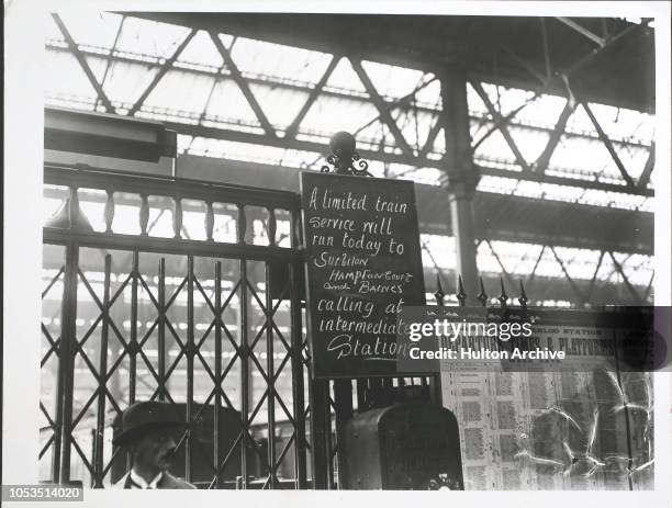 Noticeboard at a London station announces a limited service to Surbiton, Hampton Court and Barnes during the Great Railway Strike, September 1919..