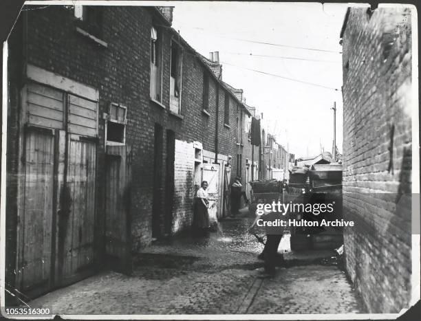 Sweeping Lynton Mews, a slum area of Bermondsey, South London, England, 18th September 1919.