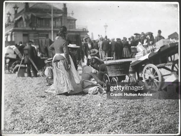 Women with a pram on the beach at Southsea, 1890s.