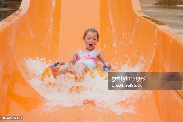 enjoying the waterslide - waterpark stock pictures, royalty-free photos & images