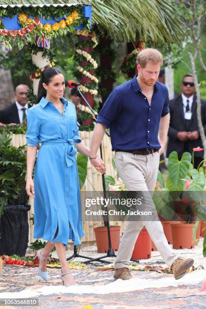 Prince Harry, Duke of Sussex and Meghan, Duchess of Sussex walking over to participate in the Unveiling of The Queen's Commonwealth Canopy at Tupou...