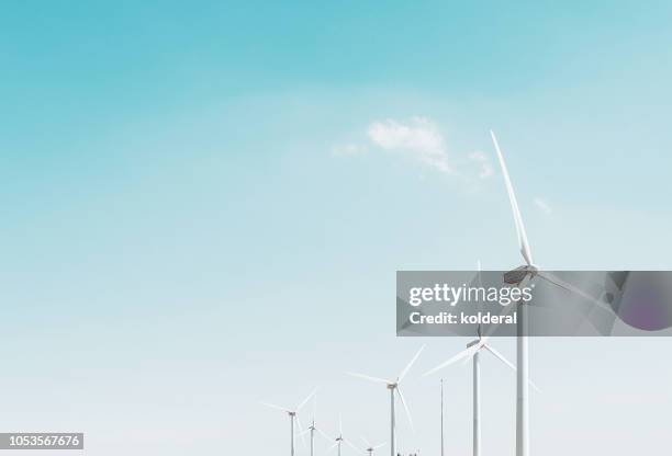 wind turbines against blue sky - clean air stock pictures, royalty-free photos & images