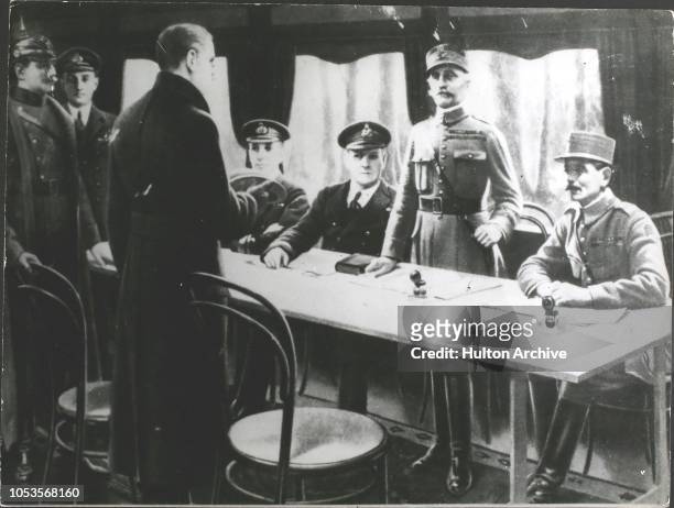 On November 11th, 1918 the Armistice was signed in a railway coach at Compiegne. Marshal Foch, French Commander, stands to receive the German...