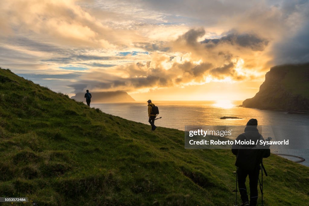 Hikers towards Drangarnir rock, Vagar island